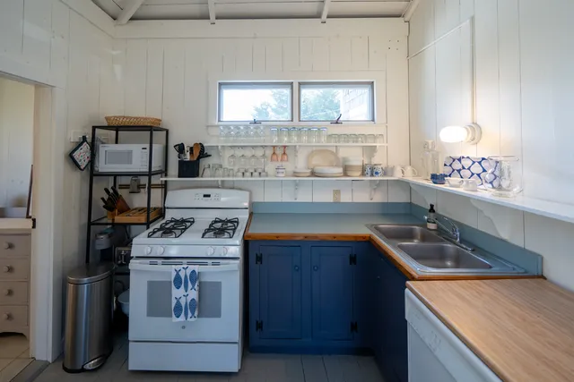 a kitchen with a sink stove and microwave