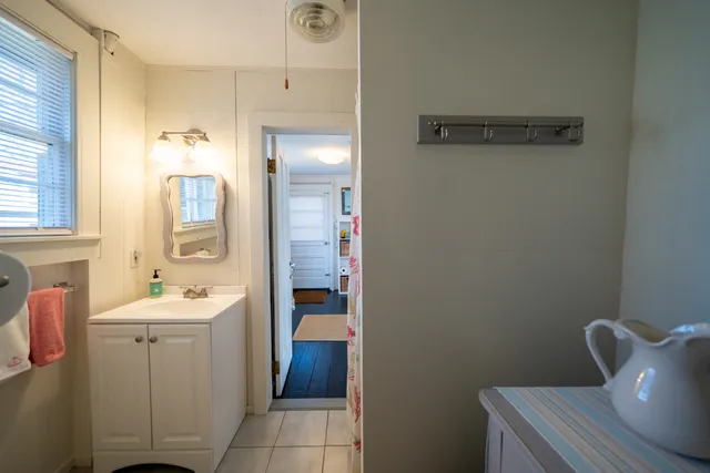 a bathroom with a sink toilet and mirror