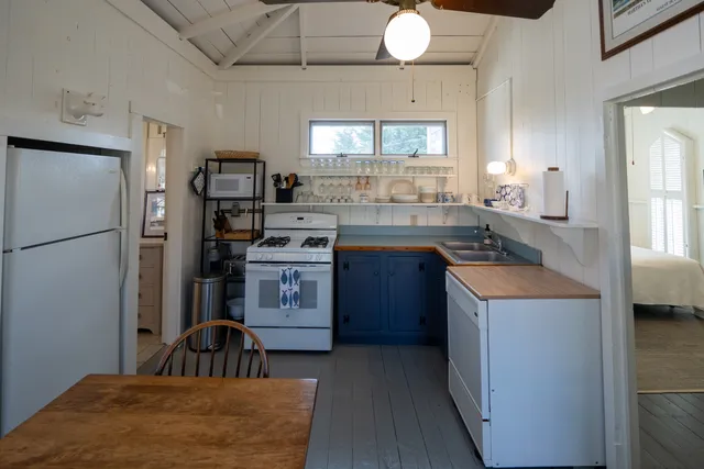 a kitchen with a refrigerator a stove a sink and a window