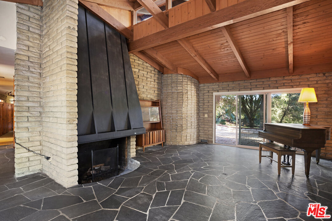 465 Cold Canyon Road Calabasas, CA 91302 - Photo 2 of 9 a view of a patio with table and chairs and wooden floor