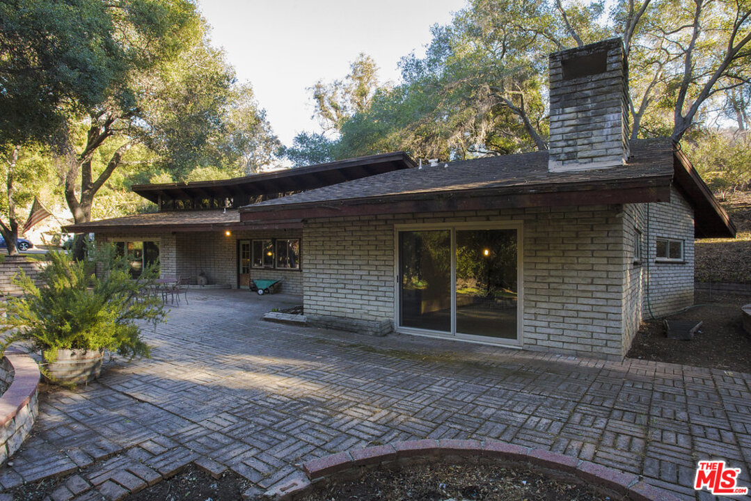 465 Cold Canyon Road Calabasas, CA 91302 - Photo 4 of 9 a front view of a house with garden