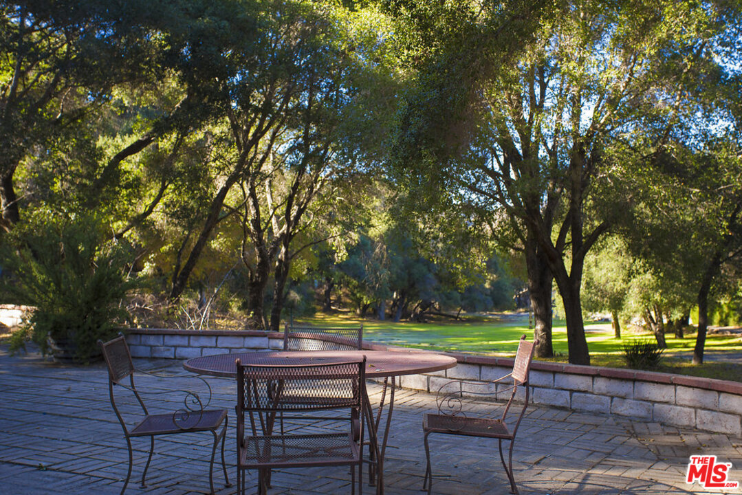 465 Cold Canyon Road Calabasas, CA 91302 - Photo 5 of 9 a view of chairs and table in a yard