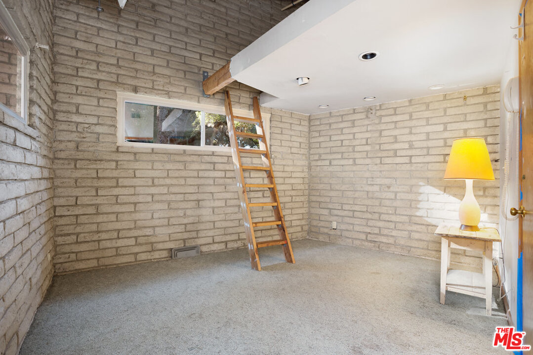 465 Cold Canyon Road Calabasas, CA 91302 - Photo 6 of 9 a view of a brick wall with an empty room