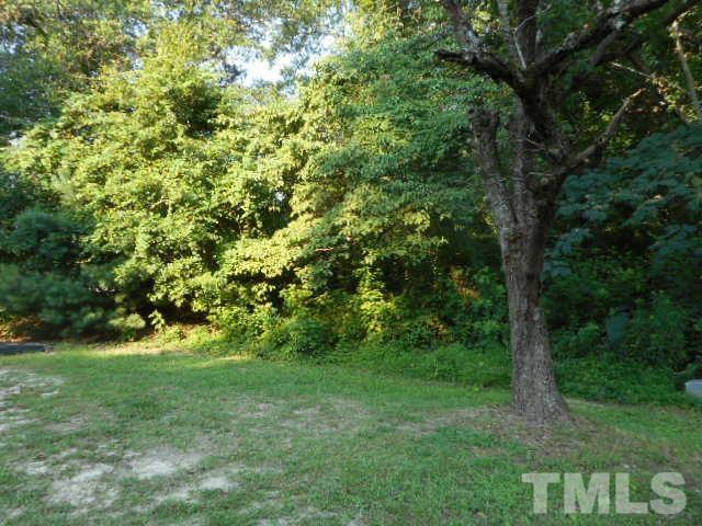 a view of a yard with a tree