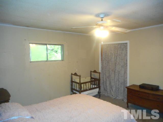 10401 Ten-Ten Road Raleigh, NC 27603 - Photo 11 of 18 a bedroom with a bed and a dresser in it