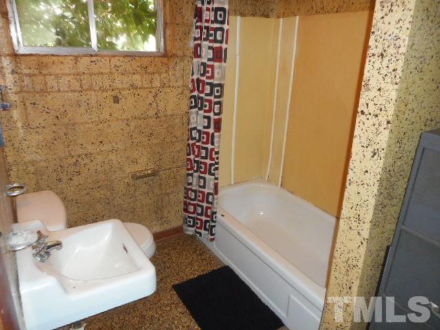 10401 Ten-Ten Road Raleigh, NC 27603 - Photo 12 of 18 a bathroom with a sink a toilet and shower
