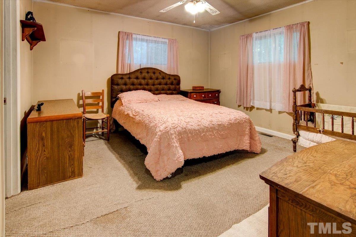 10401 Ten-Ten Road Raleigh, NC 27603 - Photo 14 of 18 a bedroom with a bed and dresser