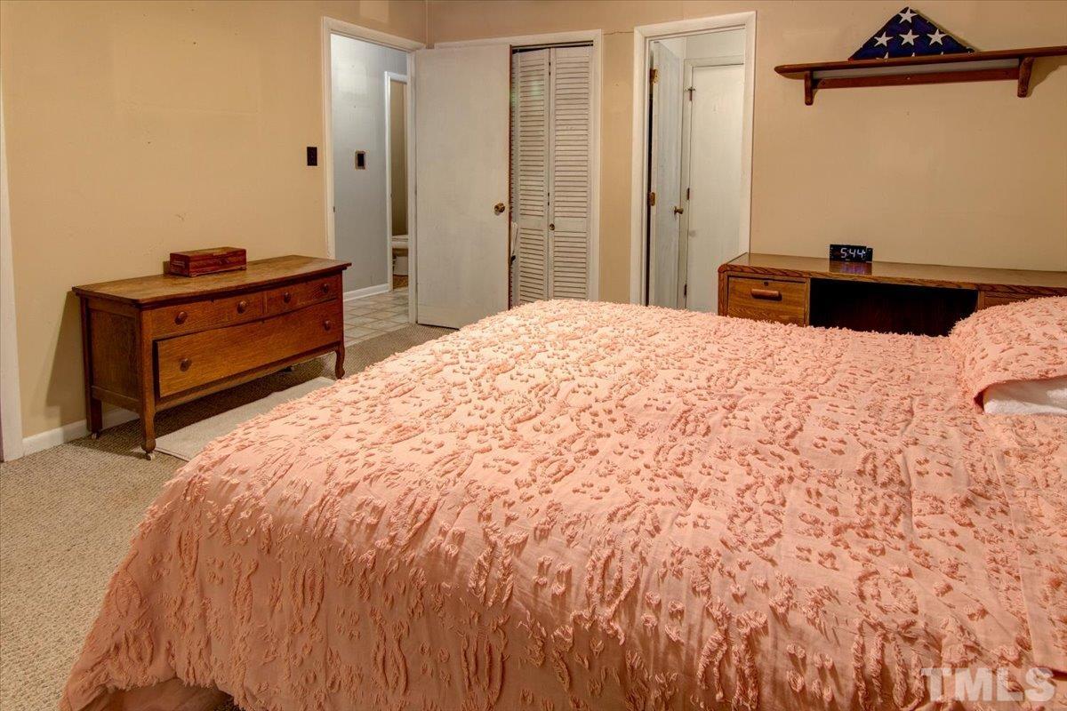10401 Ten-Ten Road Raleigh, NC 27603 - Photo 16 of 18 a bedroom with a bed and a dresser
