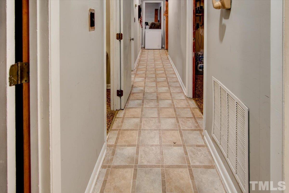 10401 Ten-Ten Road Raleigh, NC 27603 - Photo 18 of 18 a view of a hallway with wooden floor and staircase