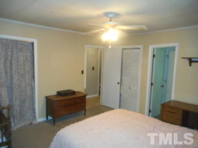 10401 Ten-Ten Road Raleigh, NC 27603 - Photo 10 of 18 a bedroom with a bed and a chandelier