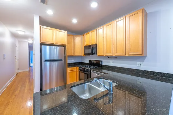 a kitchen with a refrigerator and a sink