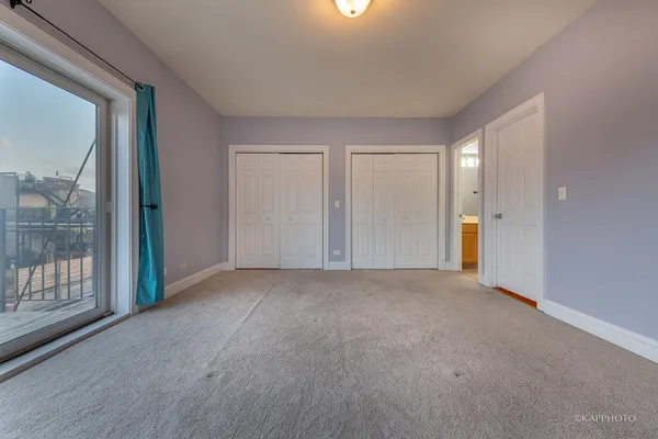 a view of an empty room with glass door