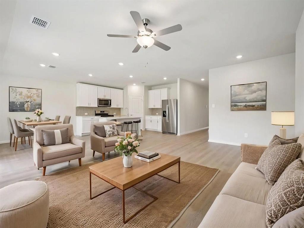 6400 Texas Ranger Trail Fort Worth, TX 76123 - Photo 3 of 14 a living room with furniture kitchen view and a chandelier