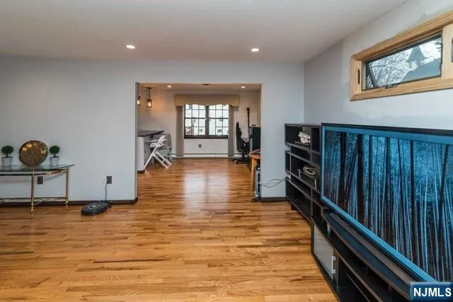 a hallway with wooden floor and furniture