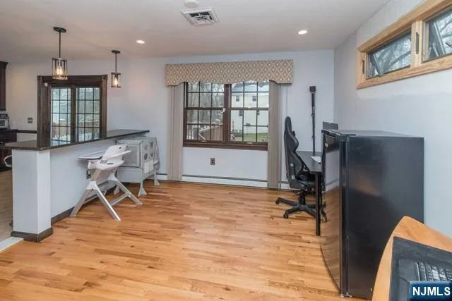 a view of a workspace with furniture and a window
