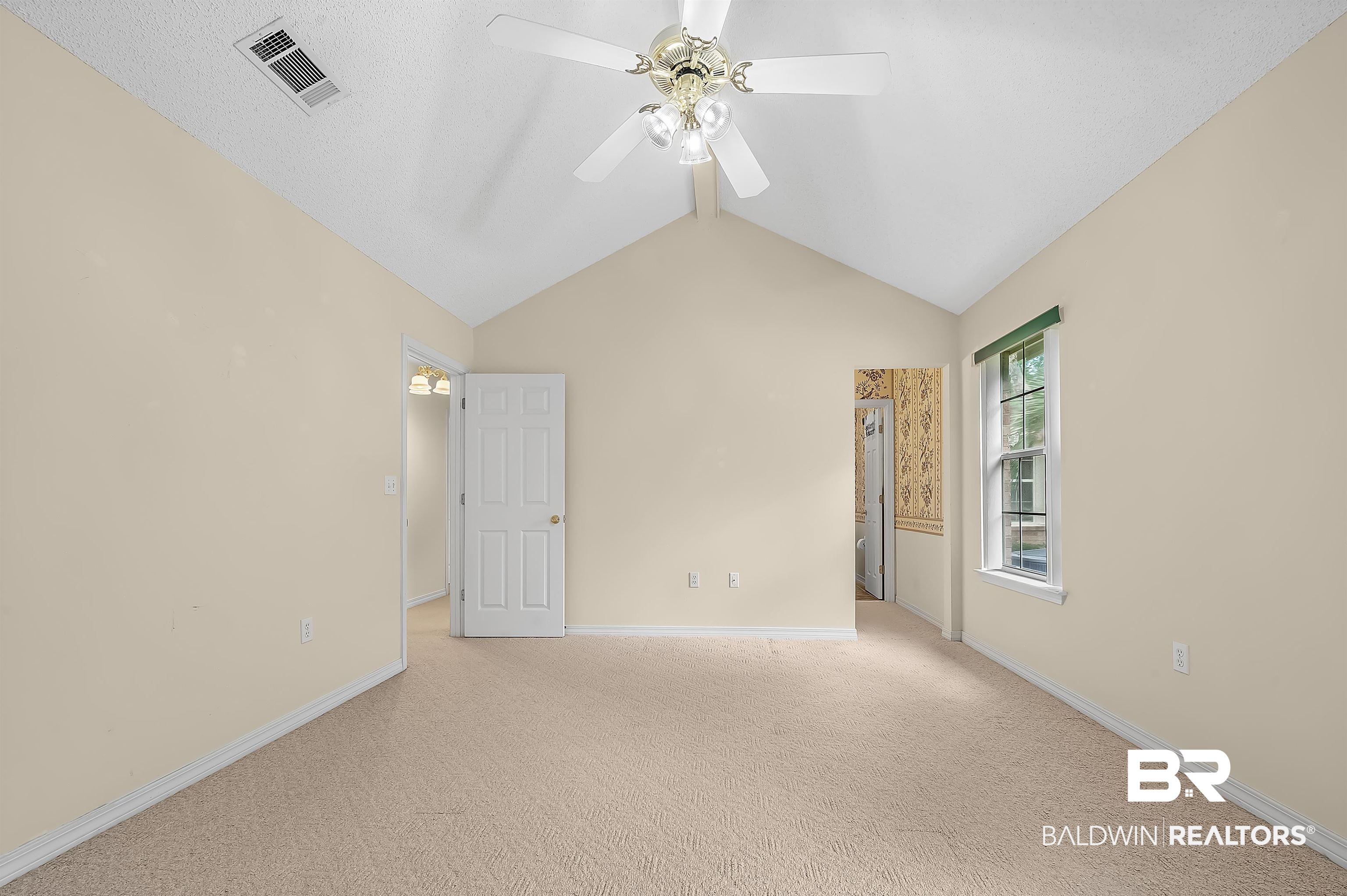1502 Mulberry Lane Foley, AL 36535 - Photo 23 of 45 featuring light carpet, vaulted ceiling, and ceiling fan