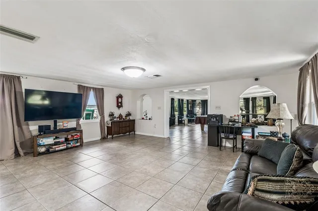 a view of a backyard with plants and a large tree