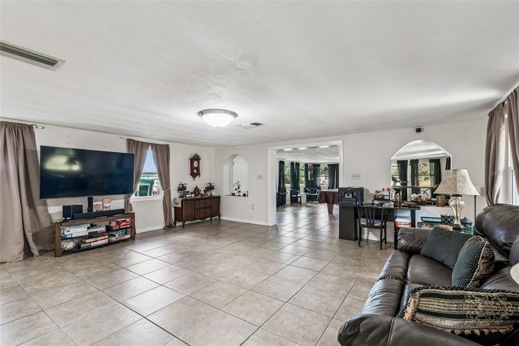 37440 Phelps Road Zephyrhills, FL 33541 - Photo 17 of 80 a living room with furniture and a flat screen tv