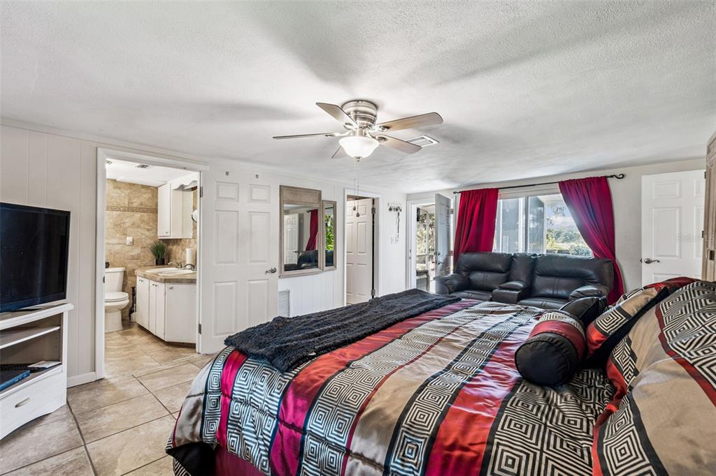 37440 Phelps Road Zephyrhills, FL 33541 - Photo 21 of 80 a bed room with a bed and furniture