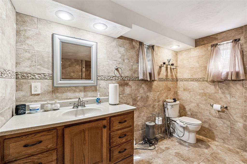 37440 Phelps Road Zephyrhills, FL 33541 - Photo 47 of 80 a bathroom with a double vanity sink toilet and a mirror