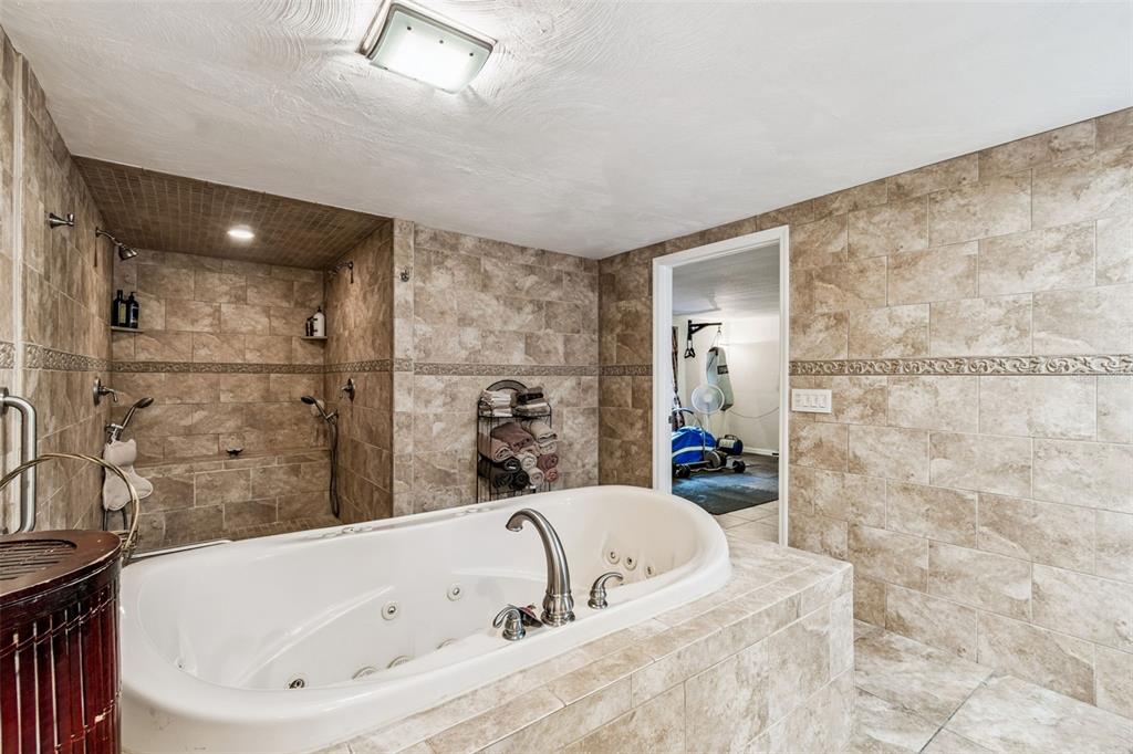 37440 Phelps Road Zephyrhills, FL 33541 - Photo 50 of 80 a bathroom with a tub a sink and a shower