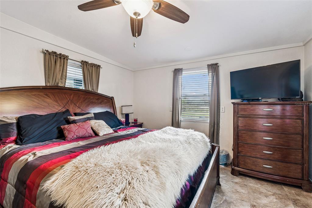 37440 Phelps Road Zephyrhills, FL 33541 - Photo 52 of 80 a bedroom with a bed and a flat screen tv