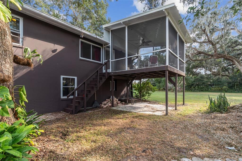 37440 Phelps Road Zephyrhills, FL 33541 - Photo 71 of 80 a backyard of a house with wooden floor and swing