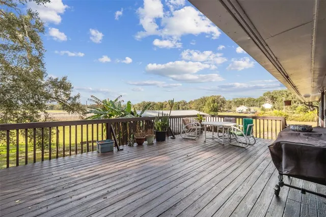 a living room with furniture a flat screen tv and gym equipment