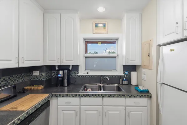 a kitchen with stainless steel appliances granite countertop a refrigerator sink and cabinets