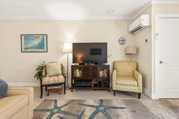 a living room with furniture a dining table and chairs