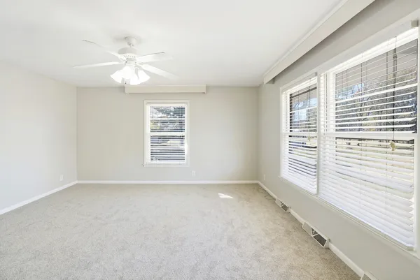a view of an empty room with a fireplace and a large window