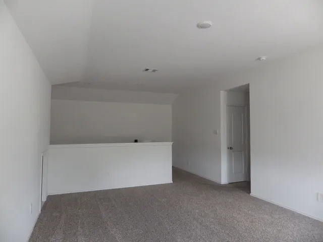 a room with a bed and a night stand