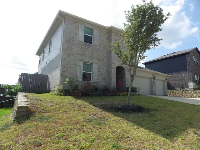 a backyard of a house with barbeque oven and outdoor seating