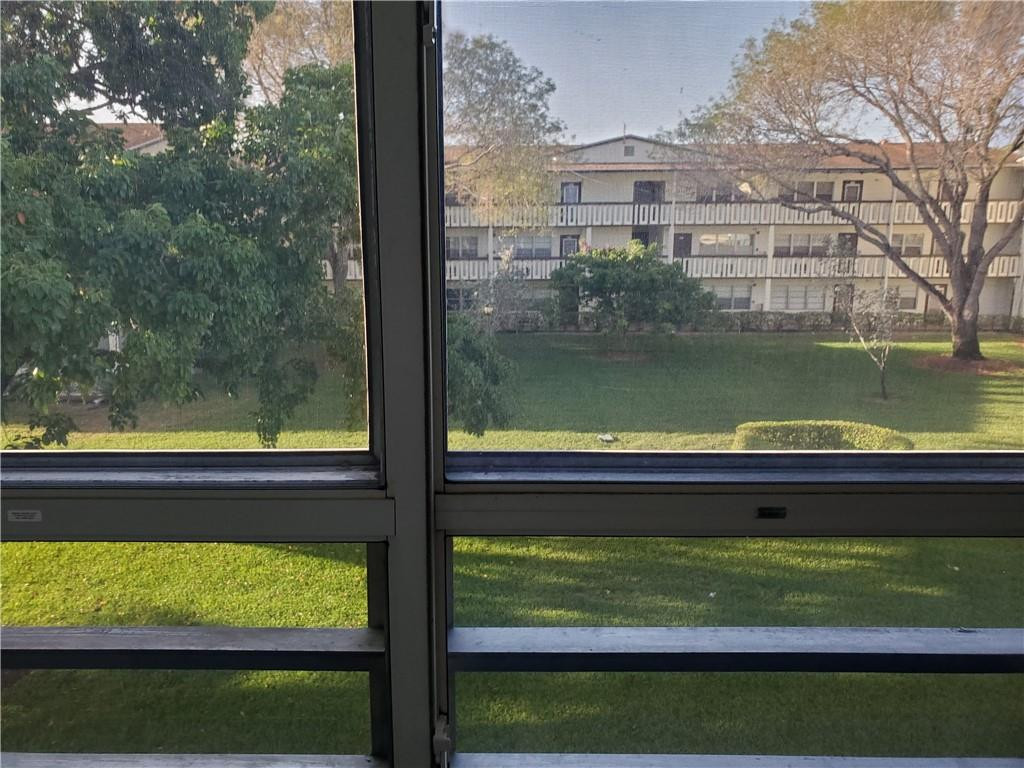 41 Suffolk A, Unit 41 Boca Raton, FL 33434 - Photo 11 of 12 a view of swimming pool from a window