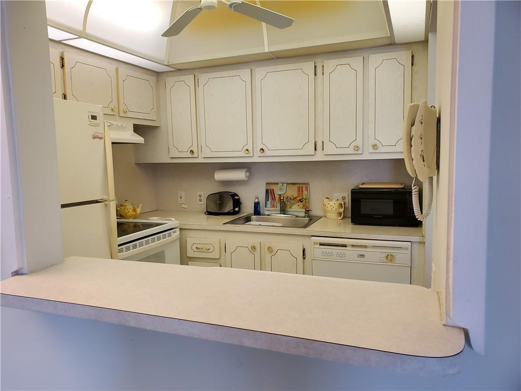 41 Suffolk A, Unit 41 Boca Raton, FL 33434 - Photo 4 of 12 a kitchen with stainless steel appliances granite countertop a refrigerator sink and white cabinets