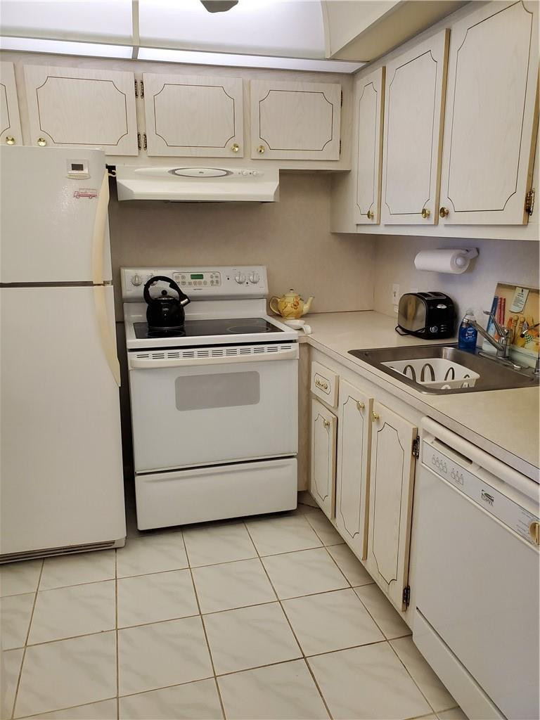 41 Suffolk A, Unit 41 Boca Raton, FL 33434 - Photo 5 of 12 a kitchen with stainless steel appliances granite countertop a sink a stove and white cabinets