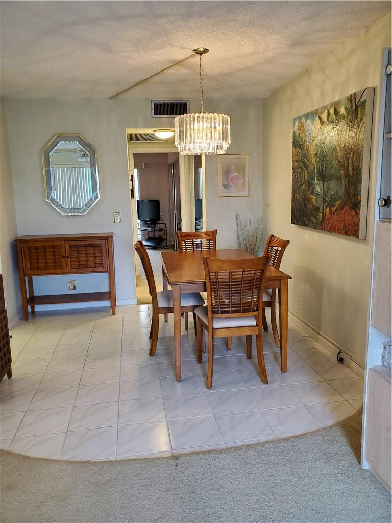 41 Suffolk A, Unit 41 Boca Raton, FL 33434 - Photo 6 of 12 a view of a dining room with furniture window and wooden floor