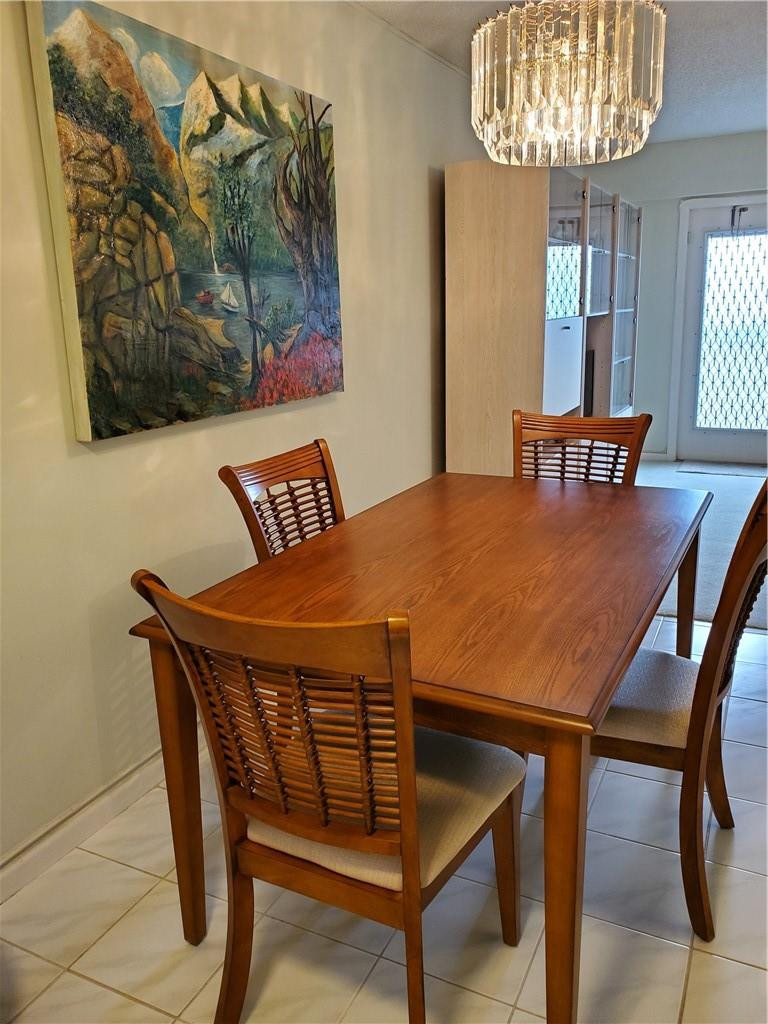 41 Suffolk A, Unit 41 Boca Raton, FL 33434 - Photo 7 of 12 a view of a dining room with furniture and chandelier