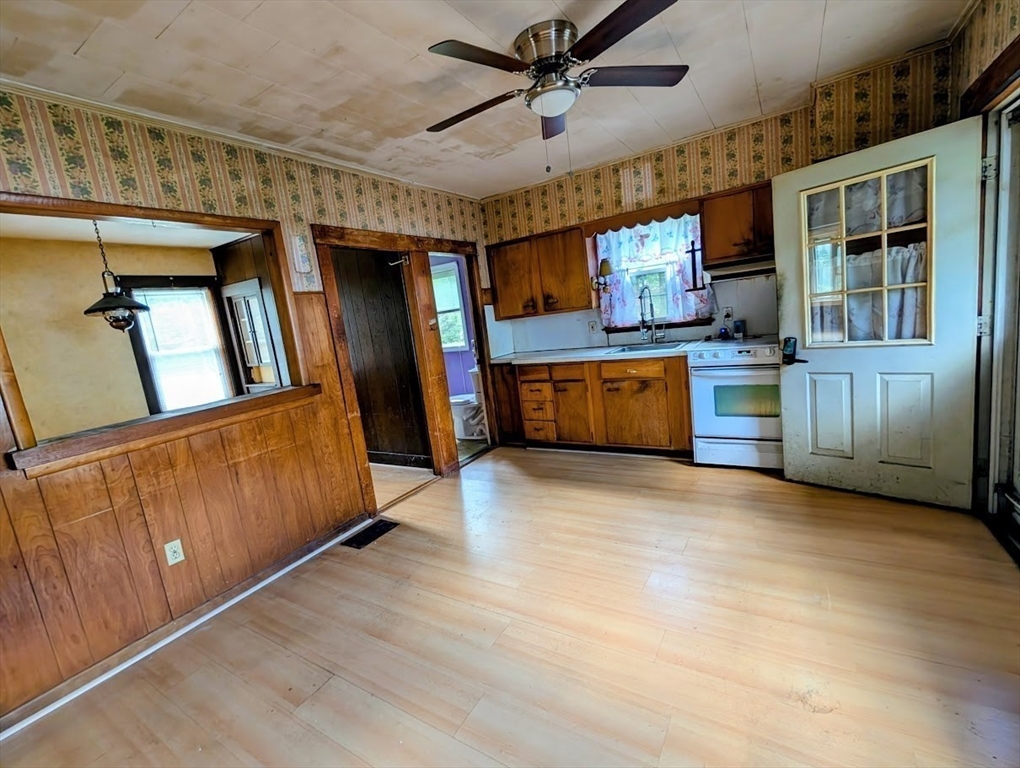 66 Brookfield Road Charlton, MA 01507 - Photo 3 of 35 a large kitchen with lot of wooden cabinets and stainless steel appliances