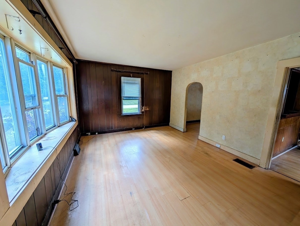 66 Brookfield Road Charlton, MA 01507 - Photo 4 of 35 a view of an empty room with a window and wooden floor