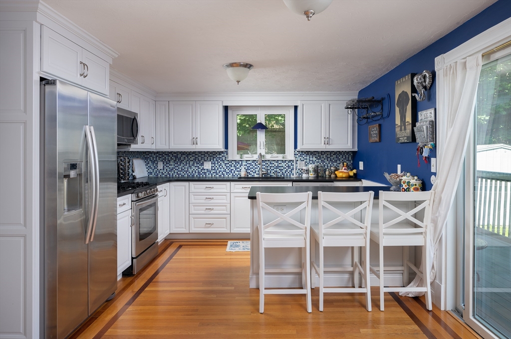 29 Wituwamat Road Weymouth, MA 02191 - Photo 12 of 42 a kitchen with stainless steel appliances granite countertop a refrigerator and a stove top oven