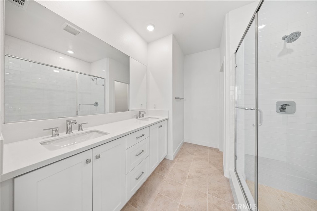 118 Abacus Irvine, CA 92618 - Photo 39 of 66 a spacious bathroom with double vanity and mirrors