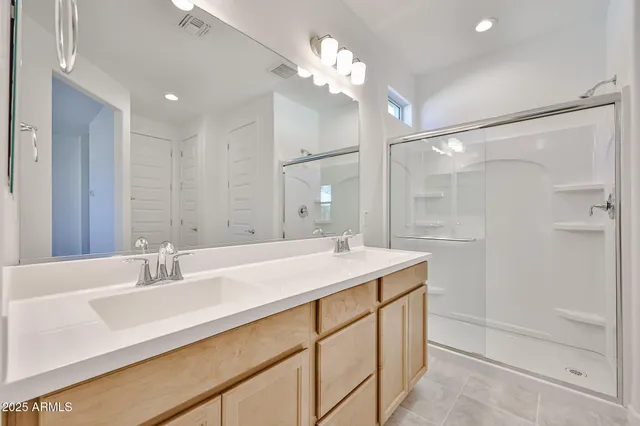 a bathroom with a sink double vanity and a mirror