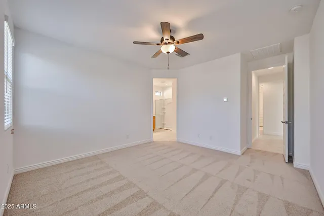 a view of empty room with a ceiling fan
