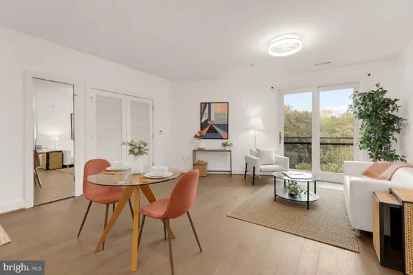 a dining room with furniture and wooden floor