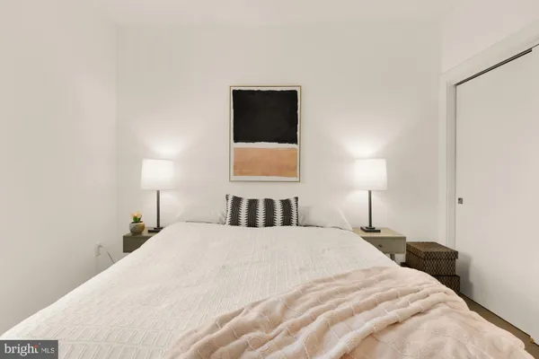 a bedroom with a bed and a lamp