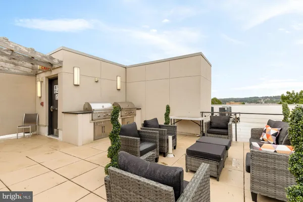 a balcony with chairs and white walls