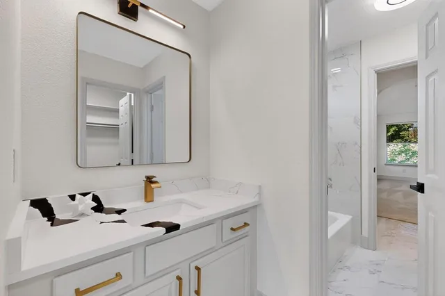 a bathroom with a sink vanity and mirror