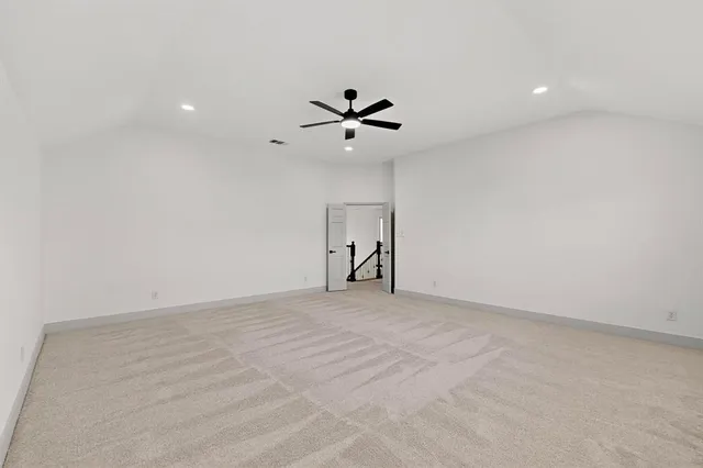 a view of an empty room with a ceiling fan