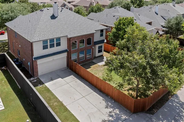 an aerial view of a house with a yard